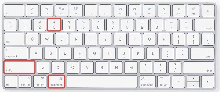 A top view of a white keyboard highlighting the shift, command, and number 3 keys with red boxes.