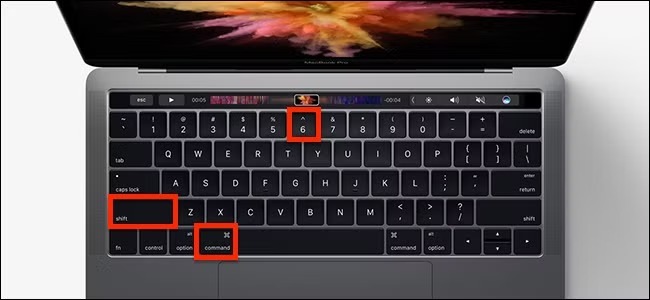 Top view of a MacBook keyboard, highlighting the Shift, Command, and number 6 keys in red boxes.