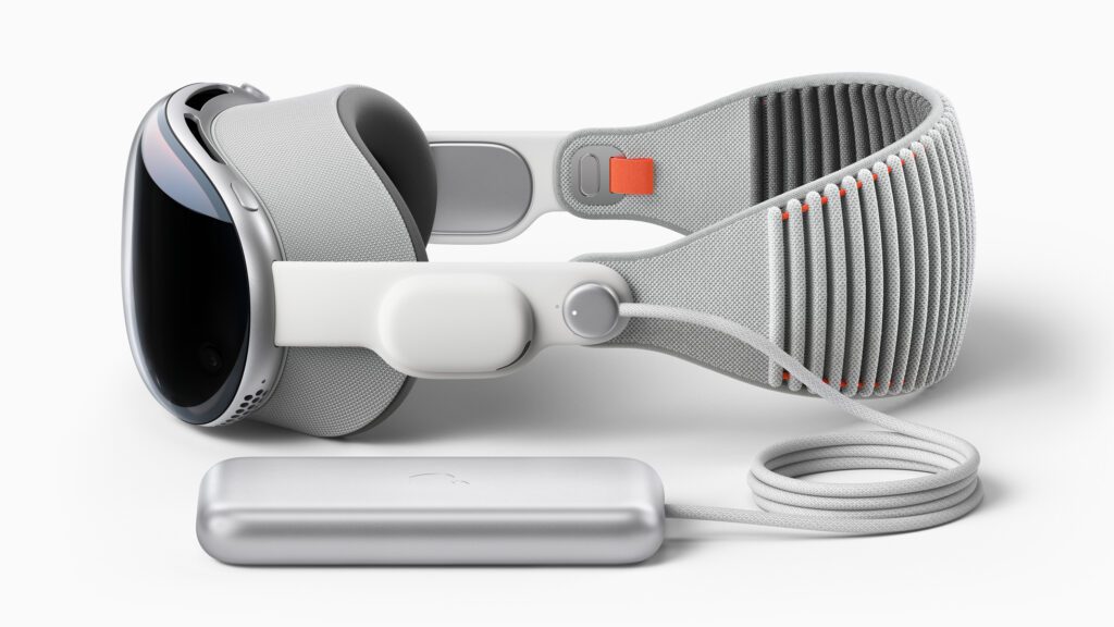 A sleek, futuristic headset in white and gray with a flexible strap, accompanied by a silver power pack and cable.