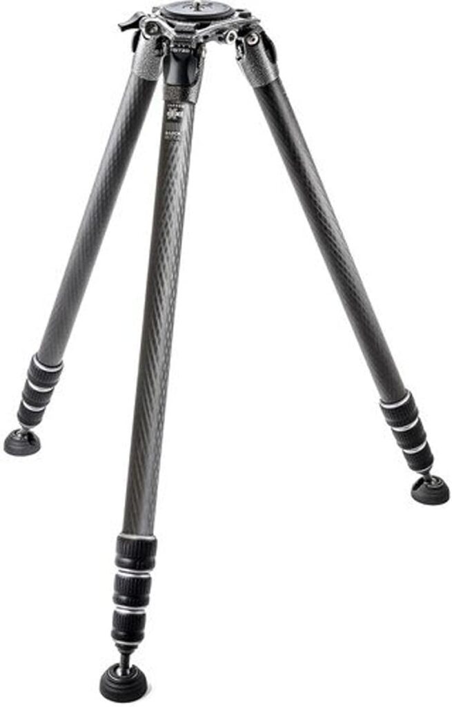 A carbon fiber tripod with adjustable legs, designed for stability in photography, featuring a rubber foot for grip and durability.