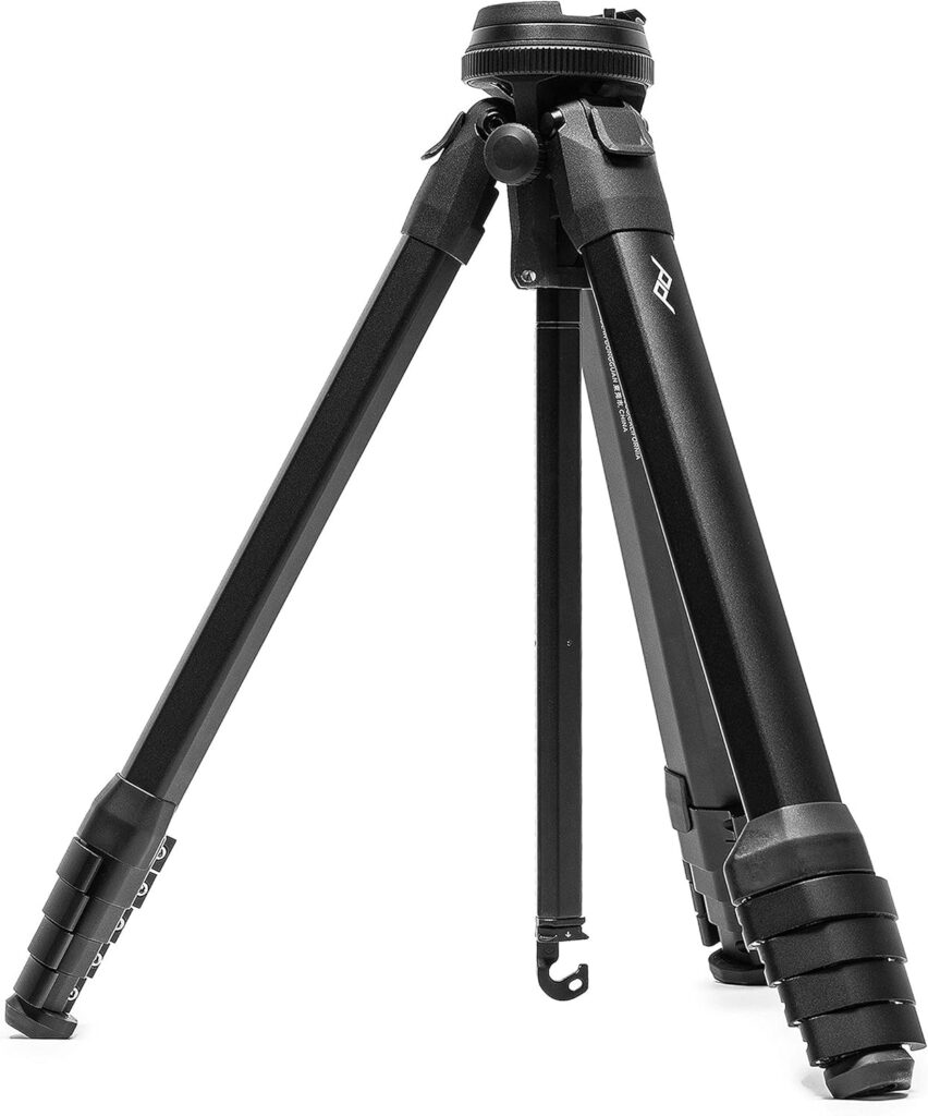 A black camera tripod with three adjustable legs, designed for stability and support in photography and videography.