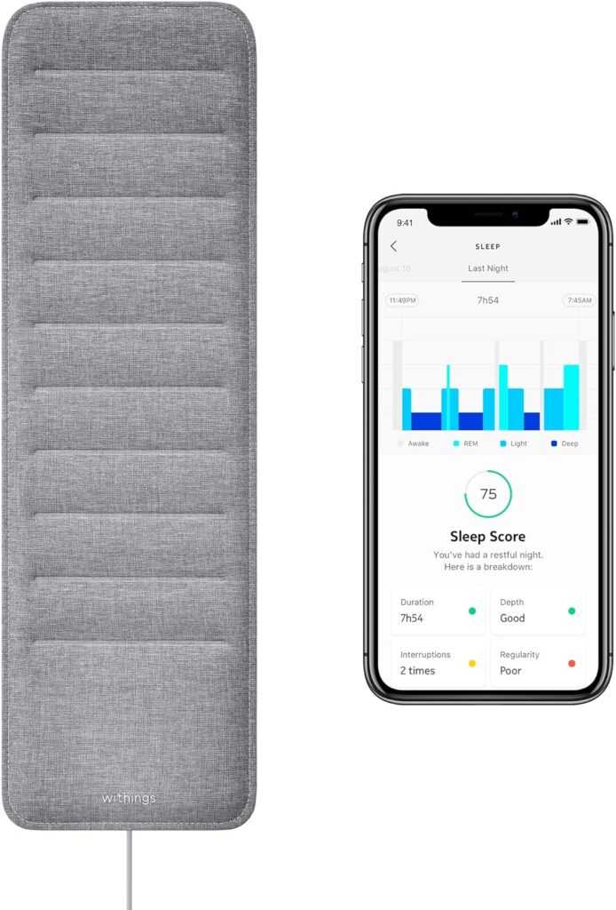 A grey sleep tracking mat alongside a smartphone displaying sleep data, including duration, interruptions, and overall sleep score.