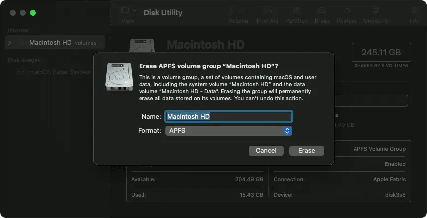 A screenshot of the macOS Disk Utility application, showing a confirmation dialog to erase the "Macintosh HD" APFS volume group. The warning explains that this action will permanently delete all data on the system and user volumes, with options to cancel or proceed.