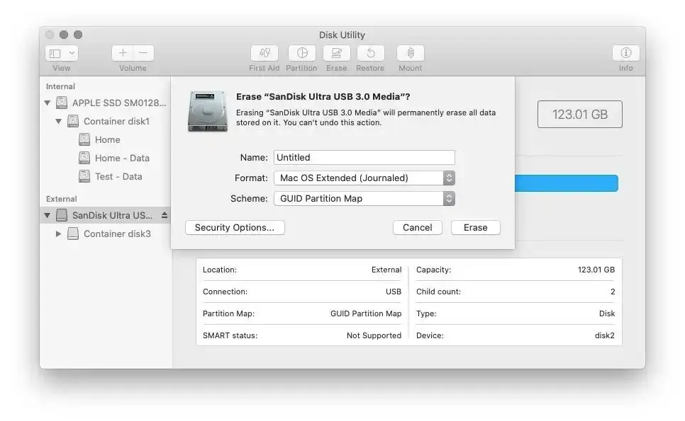 A screenshot of the macOS Disk Utility application, showing a confirmation dialog to erase an external "SanDisk Ultra USB 3.0 Media" drive. The dialog allows the user to set the name, format (Mac OS Extended), and scheme before clicking the "Erase" button.