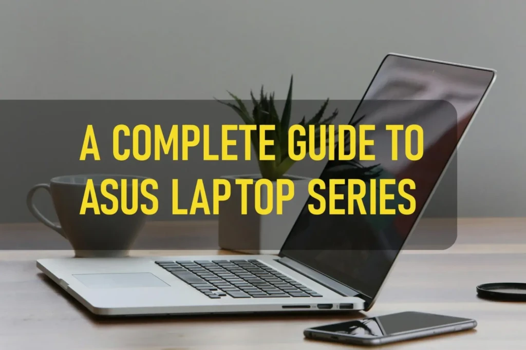 A silver laptop open on a wooden desk with a coffee cup on the left and a smartphone lying face up on the right