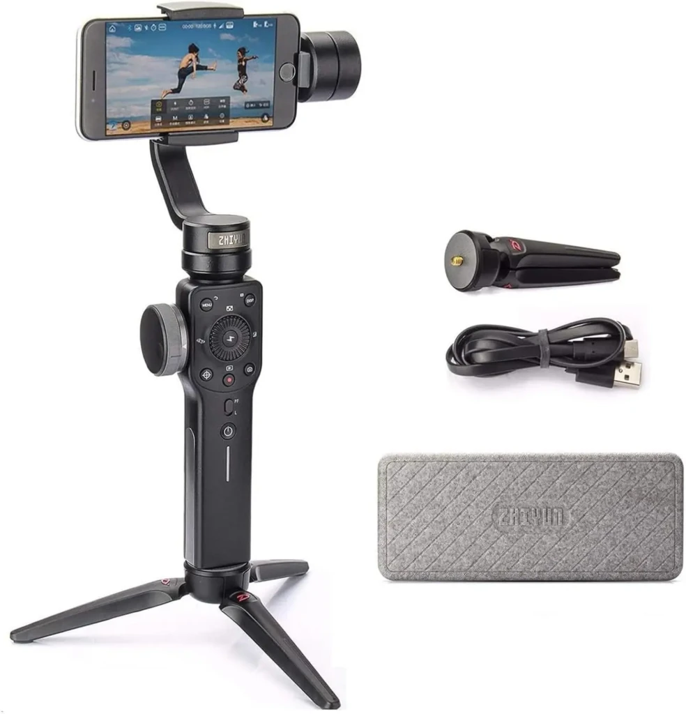 A smartphone gimbal stabilizer with control buttons, tripod legs, and accessories including a USB cable and carrying case.