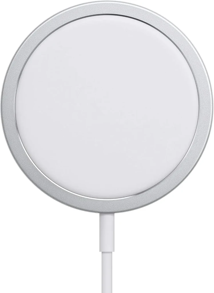 A white Apple MagSafe Charger with a circular magnetic design and silver metallic ring, connected by a white cable, emphasizing its premium build, precise alignment, and optimized charging experience for compatible iPhones.