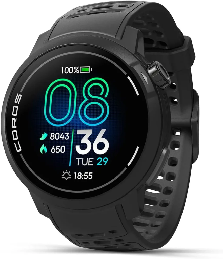 A black Coros smartwatch with a perforated sport band, displaying a vibrant digital face showing time (08:36), date (Tue 29), battery at 100%, step count (8043), and calories burned (650), highlighting its fitness tracking capabilities and bold, high-contrast display.