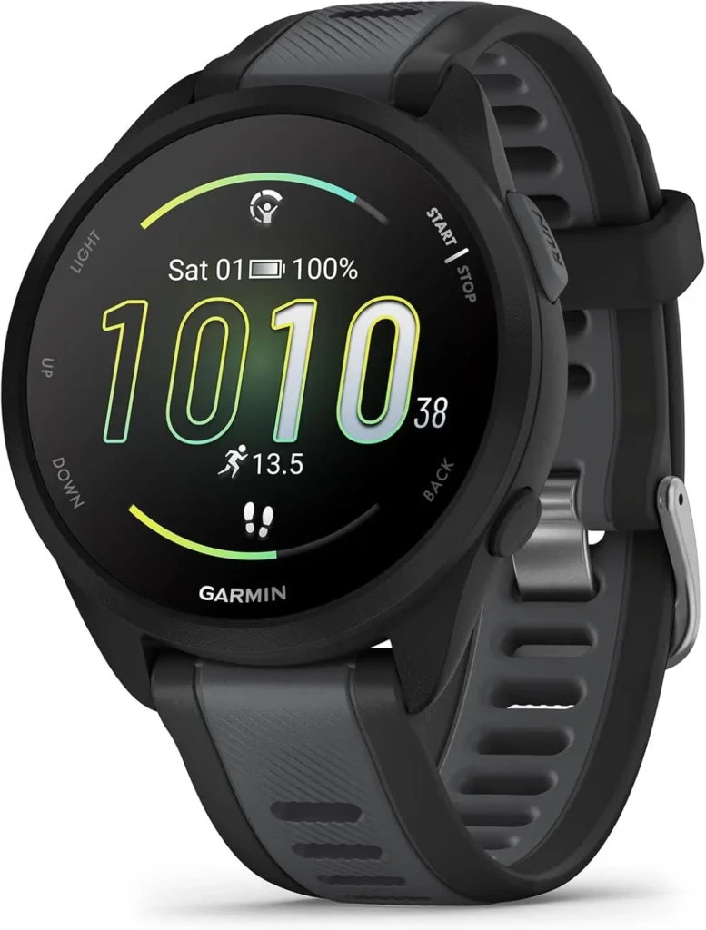 A black Garmin Forerunner smartwatch with a rugged silicone band, displaying a running workout screen with time (10:10), date (Sat 01), 100% battery, and 13.5 km distance, showcasing its endurance tracking features and durable design for serious runners.