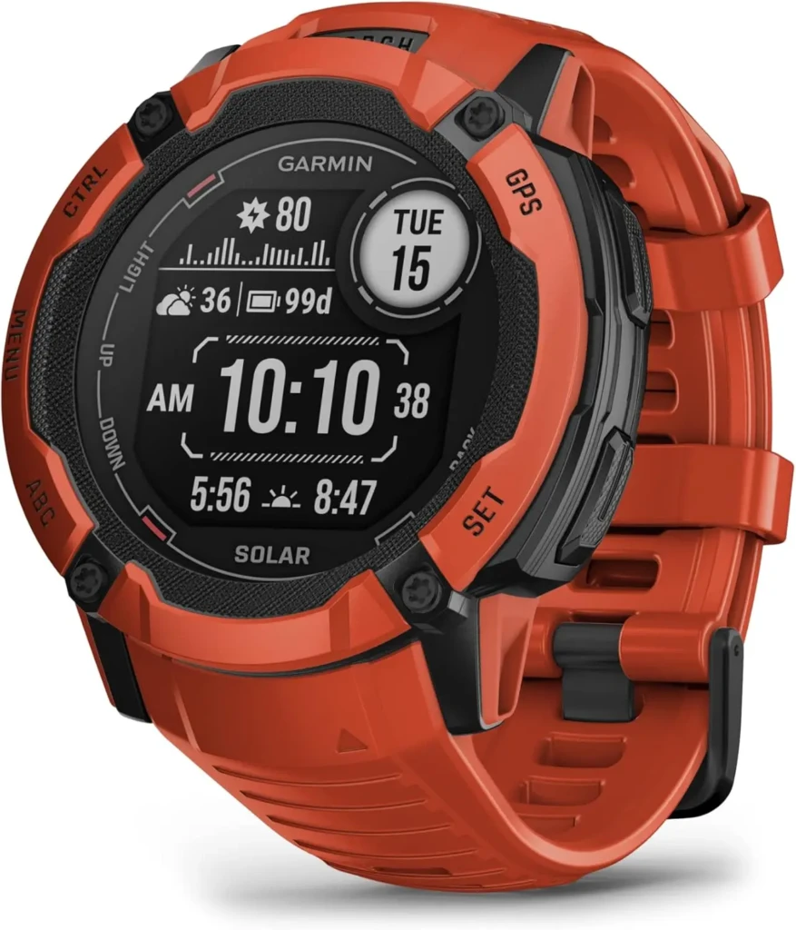 A rugged orange Garmin Instinct Solar smartwatch with a textured bezel and durable design. The screen shows time (10:10 AM), date (Tue 15), weather (36°F), battery life (99 days), and solar charging status — highlighting its outdoor-ready features and long-lasting power