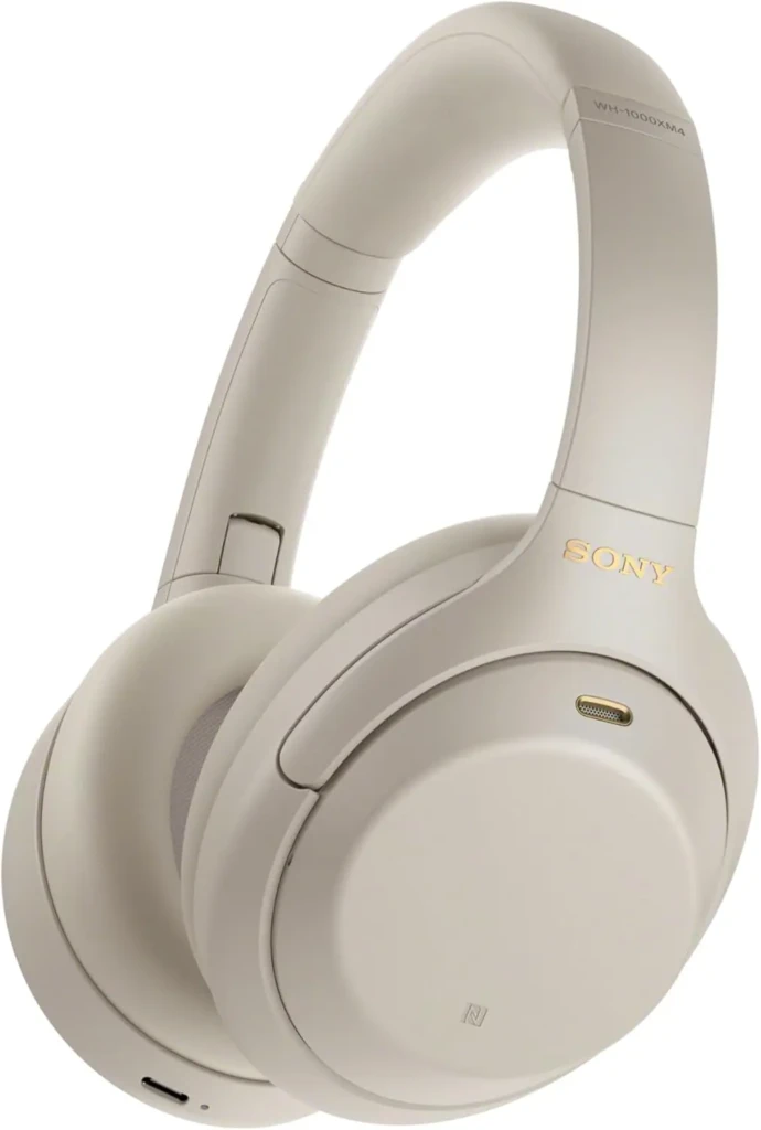 Close-up of Sony WH-1000XM4 wireless headphones in a light beige color, showcasing sleek design and features like touch controls.