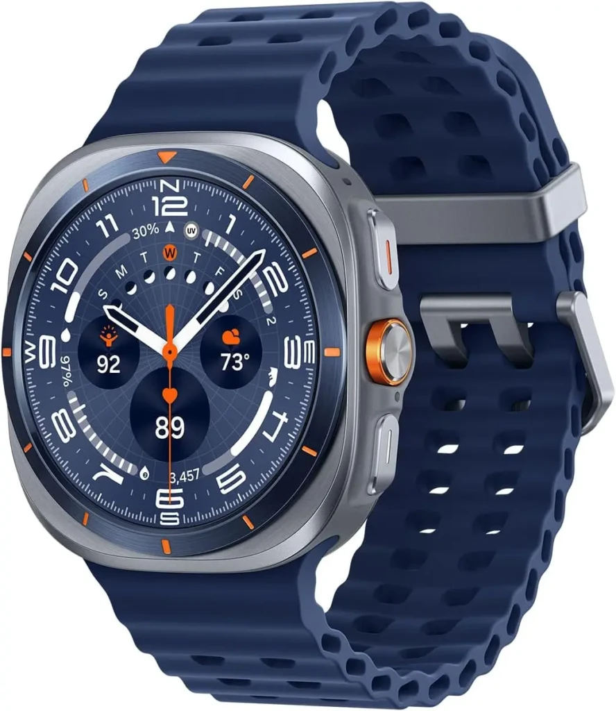 A close-up of the Samsung Galaxy Watch Ultra in Titanium Blue, featuring a perforated silicone strap and brushed metal case. The detailed watch face displays time, heart rate (89 bpm), weather (73°F), UV index, and steps (3,457), with orange accents highlighting key metrics