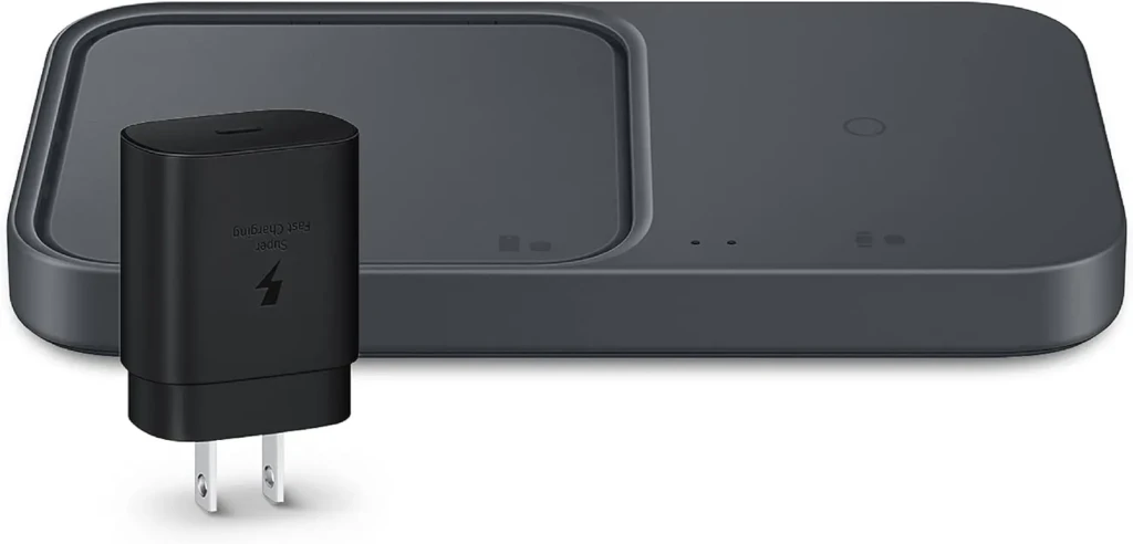 A sleek black Samsung wireless charging pad with dual zones, one larger rectangular area for phones or tablets and a smaller circular spot for earbuds or watches, showcasing its minimalist design and multi-device charging capability on a white background.