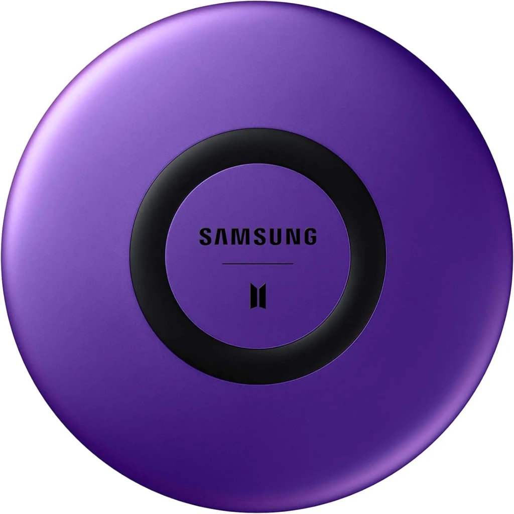 A vibrant purple Samsung Galaxy Buds charging case featuring the Samsung logo and BTS logo at the center, encircled by a black ring, representing a special edition collaboration product designed for fans and wireless audio enthusiasts.