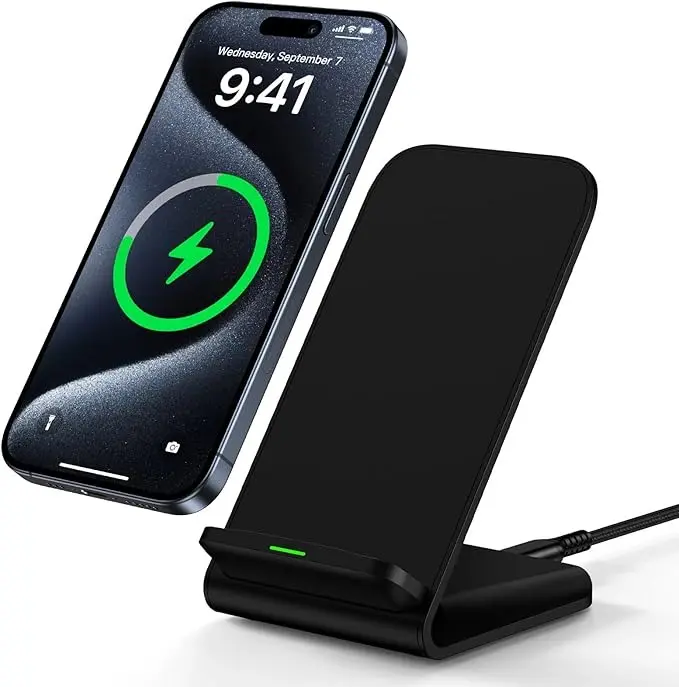 A black Samsung wireless charging stand holding an iPhone displaying a green charging animation, with a glowing green indicator light on the base, illustrating its upright charging position and universal compatibility with Qi-enabled devices.