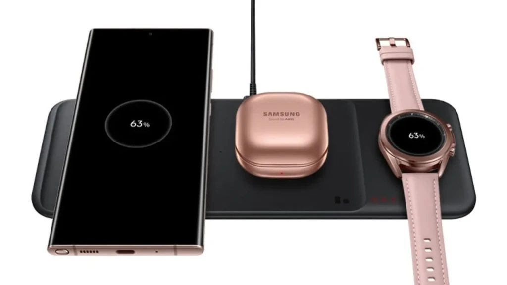 A Samsung multi-device wireless charging pad simultaneously powering a smartphone, Galaxy Buds case, and smartwatch, all displaying 63% battery level, highlighting its ability to charge multiple compatible devices at once for seamless daily use.