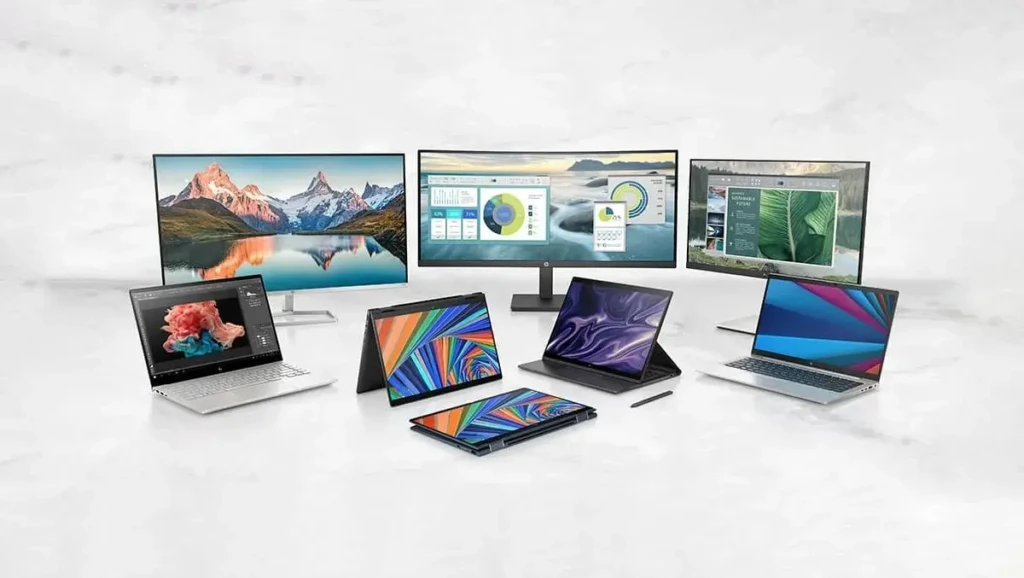 A curated lineup of HP devices including laptops, convertible tablets, and monitors arranged on a marble surface. Each screen displays vivid, colorful content, from nature landscapes to data dashboards, showcasing versatility for creative and professional use