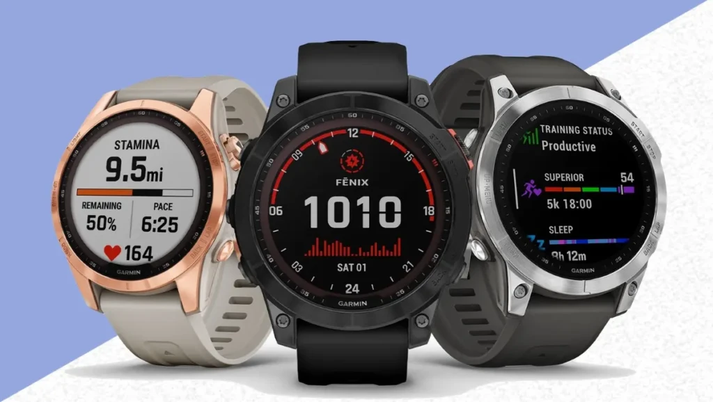 Three Garmin Fenix watches side by side against a blue-and-white background, each displaying a different specialized watch face: Stamina (distance and pace), classic analog-digital time (10:10), and Training Status (Productive/Superior). Highlights the variety of performance metrics and customization options across models
