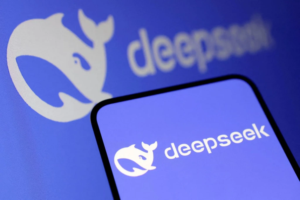 A smartphone displaying the DeepSeek app logo against a blurred background featuring a larger version of the same blue whale logo, emphasizing brand identity and reinforcing recognition across devices.