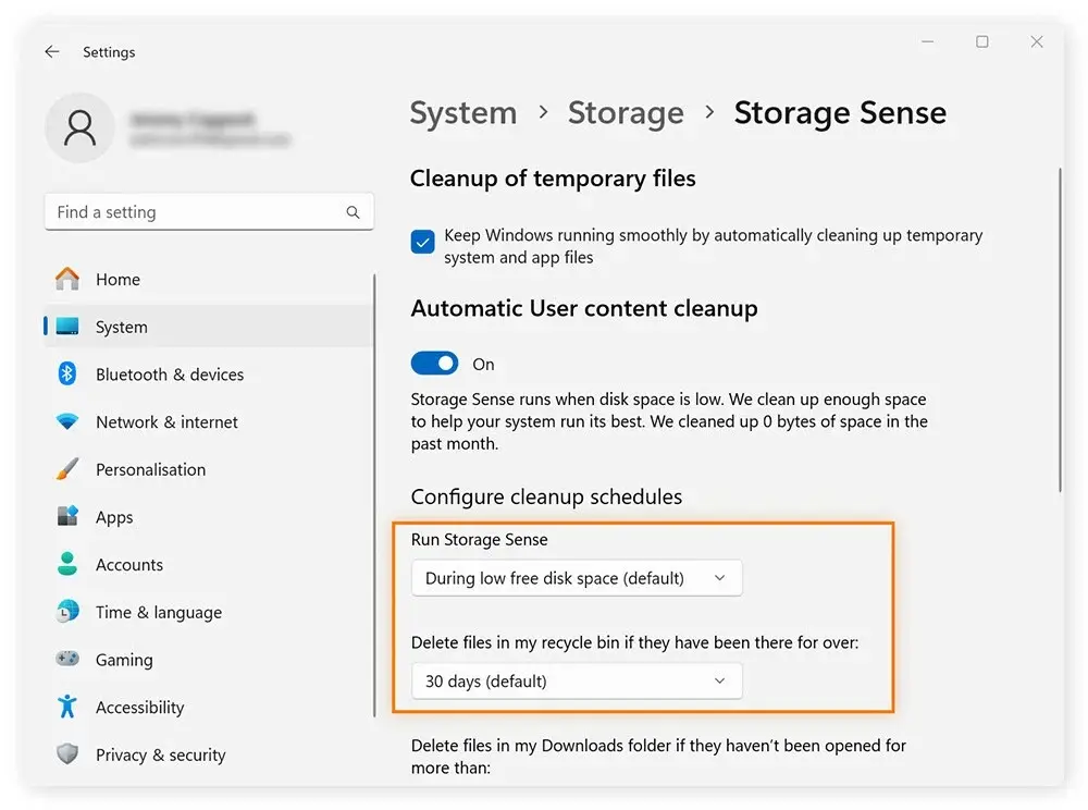 Windows Settings under System > Storage > Storage Sense, showing automatic cleanup options. The “Run Storage Sense” setting is configured to trigger “During low free disk space,” and recycle bin files older than “30 days” are set to auto-delete, helping maintain optimal system performance