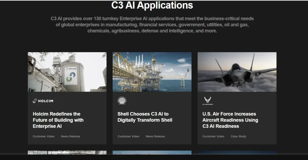 A section titled “C3 AI Applications” showcasing three customer case studies: Holcim (manufacturing), Shell (oil & gas), and U.S. Air Force (defense), each with imagery, logos, and headlines highlighting how C3 AI transforms operations in critical industries, emphasizing real-world enterprise adoption across sectors.
