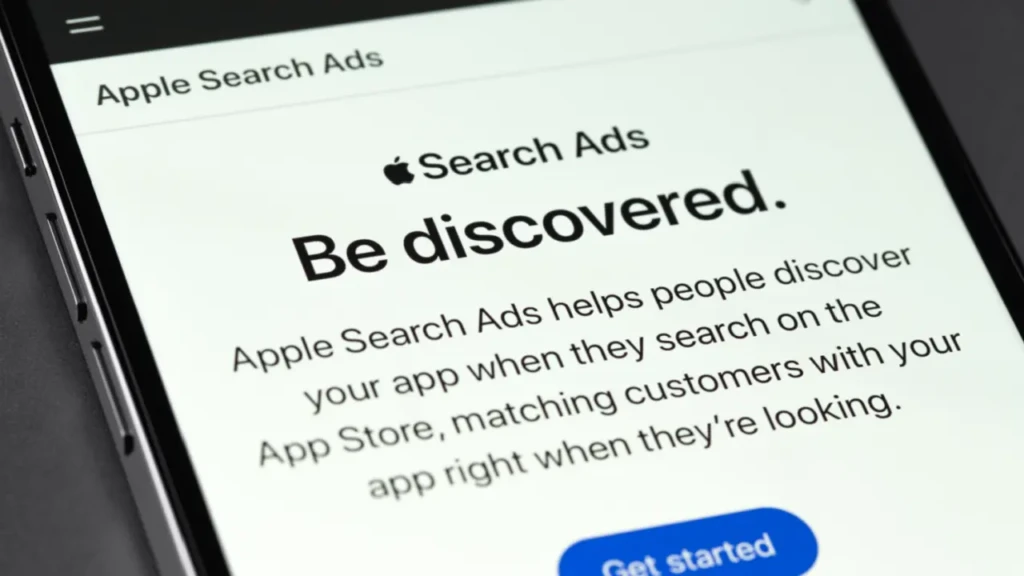 Screenshot of Apple Search Ads webpage displaying the text "Be discovered" and details on promoting apps in the App Store.