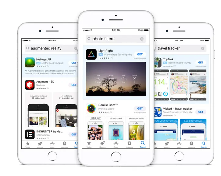 Three white iPhones displaying the App Store interface with search results for “augmented reality,” “photo filters,” and “travel tracker,” highlighting app listings like NoMoss AR, LightRight, and TripTrek — illustrating how Apple Search Ads appear prominently at the top of search results.