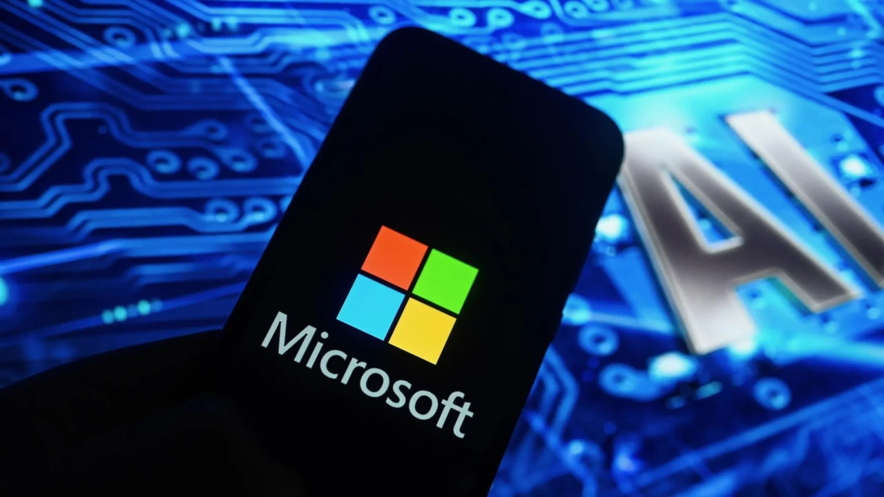 A smartphone displays the Microsoft logo against a blue digital background with 'AI' illuminated prominently.