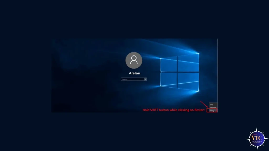 The Windows login screen for user “Arslan,” showing the default blue window wallpaper, with a red annotation pointing to the power icon and text instructing: “Hold SHIFT button while clicking on Restart,” illustrating the method to access Advanced Startup Options for system recovery.