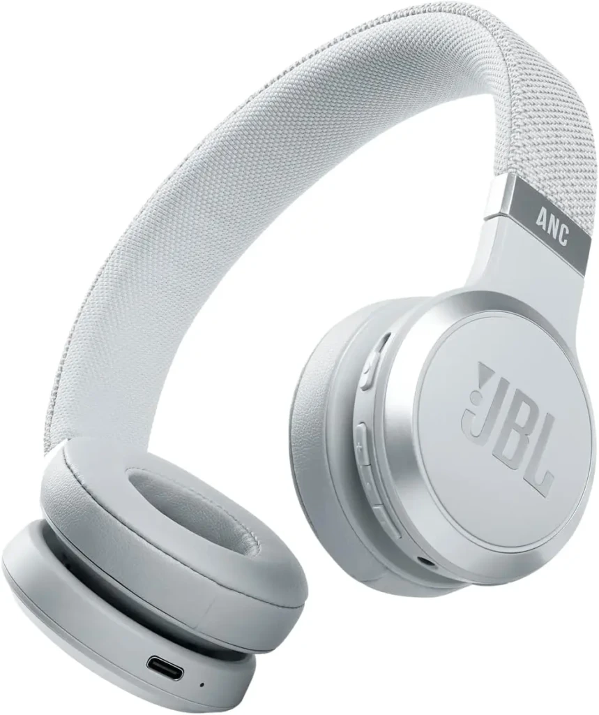 A light gray JBL over-ear headphone featuring a breathable fabric headband labeled “ANC,” soft padded earcups, and visible USB-C port, showcasing its active noise cancellation capability and comfortable, everyday-wearable design.
