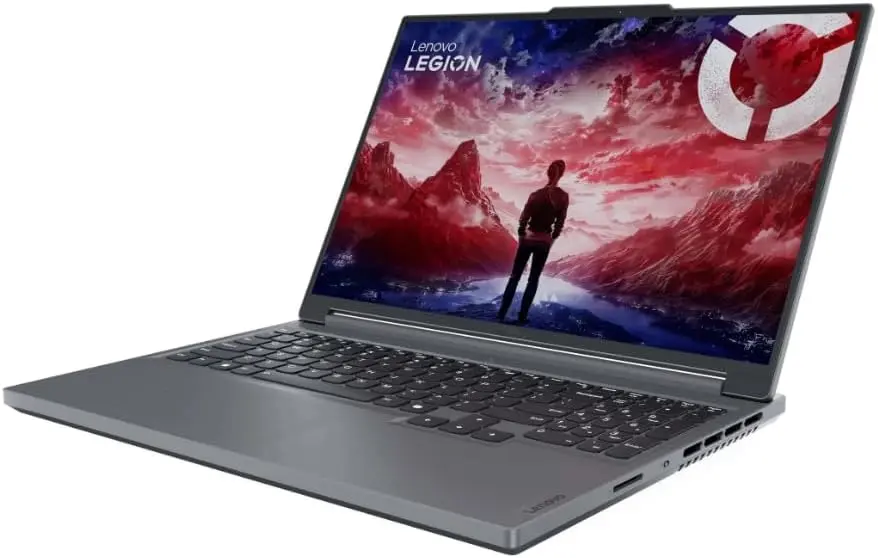A gray Lenovo Legion gaming laptop open at an angle, displaying a dramatic fantasy wallpaper with a silhouetted figure against red-and-blue mountains and the “Lenovo LEGION” logo in the top-left corner, emphasizing its immersive display and gaming-oriented branding.