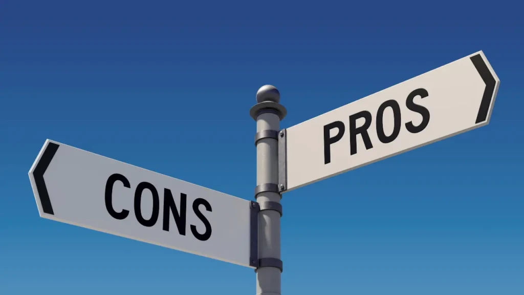 Street sign pointing in two directions labeled "PROS" and "CONS" against a clear blue sky.