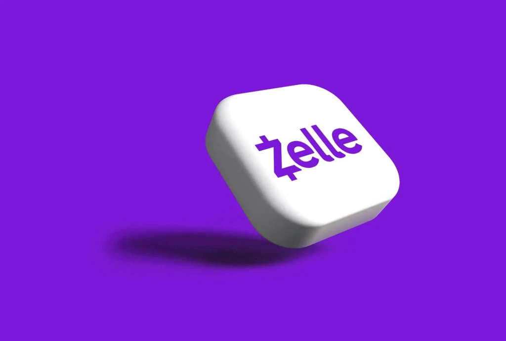 A white, rounded-square 3D icon with the purple “Zelle” logo floating against a vibrant purple background, casting a soft shadow, representing the brand’s modern, clean identity in a minimalist promotional style.