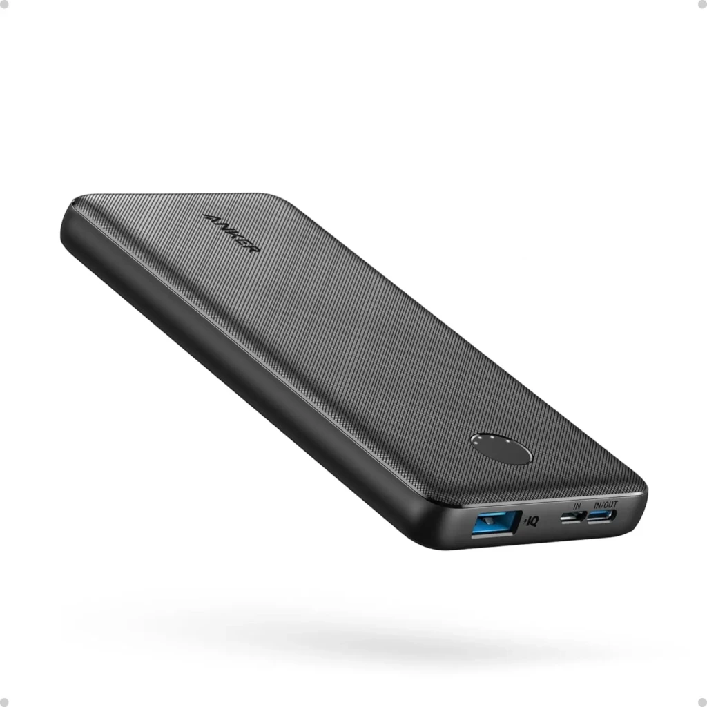 A black Anker power bank with a textured diagonal-line finish, the “ANKER” logo subtly embossed, a circular LED indicator, and dual USB ports (one marked “IQ”) on the side, showcasing sleek industrial design and intelligent charging technology.