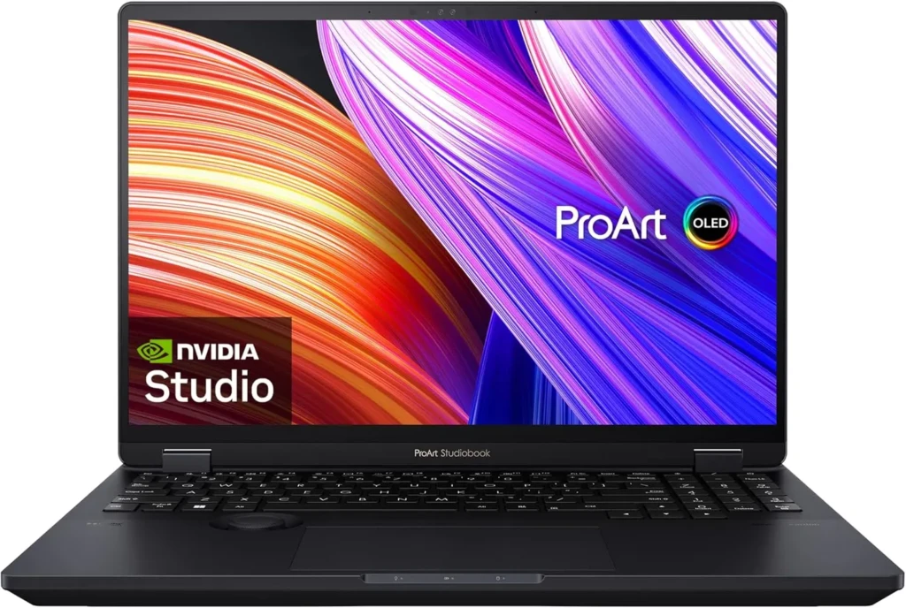 A black ASUS ProArt Studiobook laptop with an OLED display showing vibrant abstract streaks and the “ProArt” logo; the NVIDIA Studio badge appears in the bottom-left corner, highlighting its professional-grade design for creative workflows and color-accurate content creation.