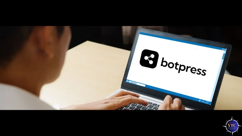 A person using a laptop shows the Botpress logo on the screen. The scene conveys a professional and focused atmosphere, suggesting tech engagement.