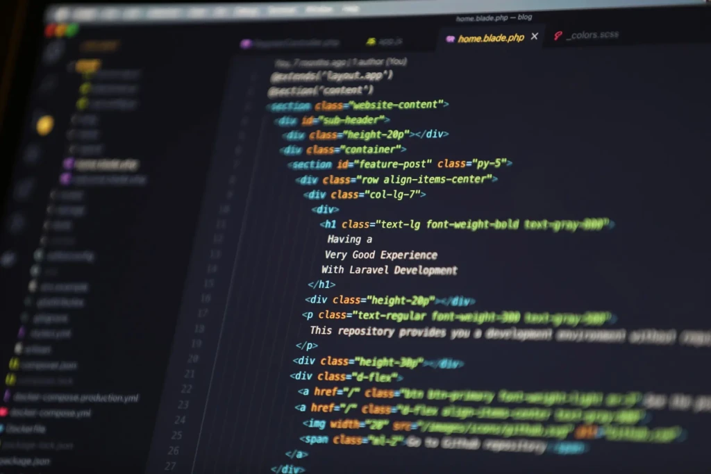 A close-up of a code editor displaying HTML and Blade template syntax (e.g., @extends, @section) with Laravel-specific content like “Very Good Experience With Laravel Development,” alongside a file explorer sidebar showing .env, composer.json, and Dockerfile, illustrating a PHP/Laravel web development workflow.