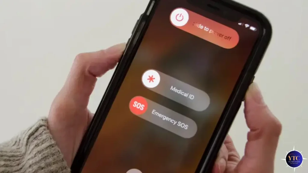 Hand holding smartphone displaying the "slide to power off," "Medical ID," and "Emergency SOS" options on screen.