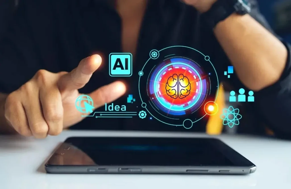 Person interacting with a digital AI interface projection above a tablet, featuring a brain, AI, idea, and network icons.