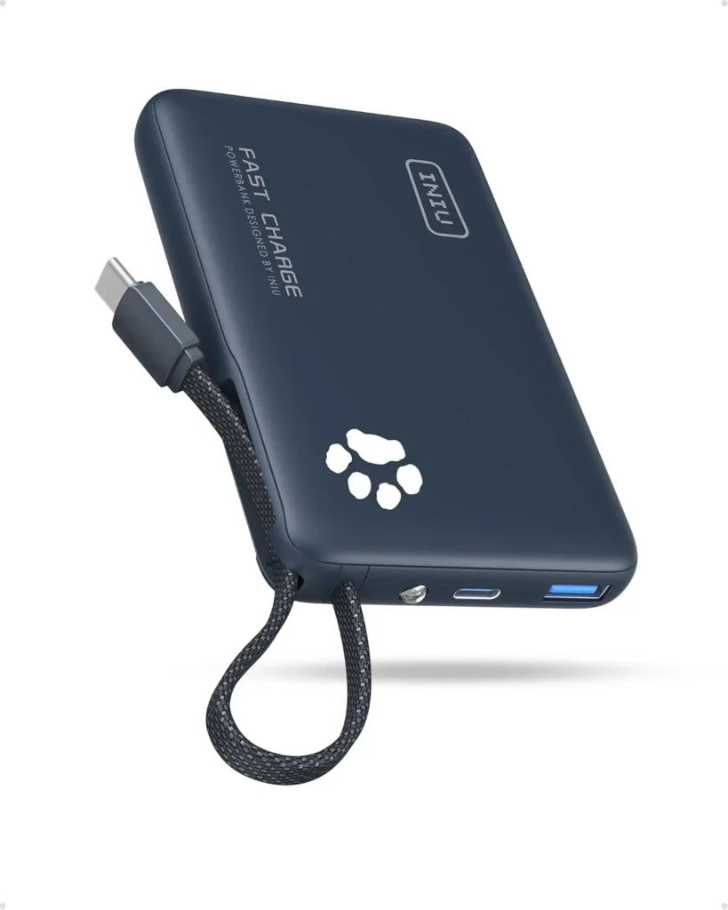 A navy-blue INIU Fast Charge power bank with a built-in USB-C cable looped through a woven strap, featuring a white paw-print logo, the “INIU” brand mark, and visible USB-A and USB-C ports, highlighting compact design and integrated cable convenience.