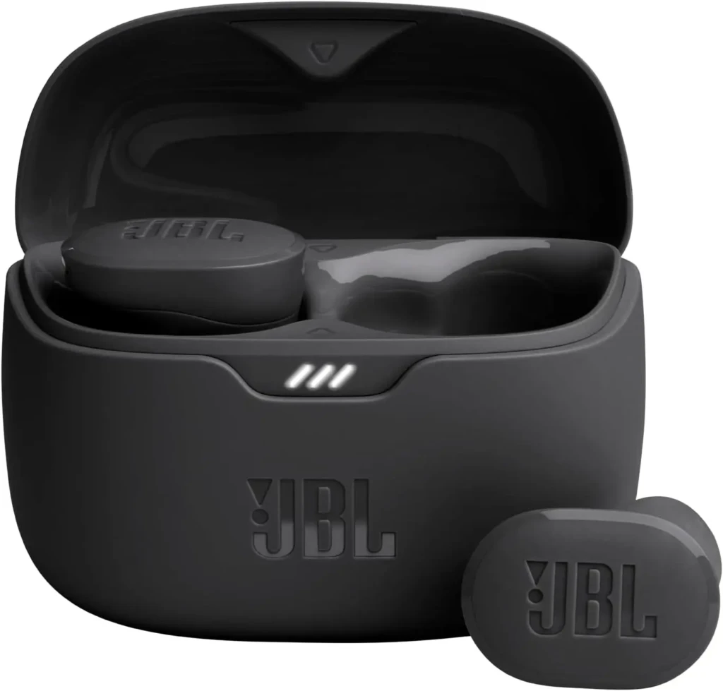 A black JBL earbud case with the embossed “JBL” logo, lid open to reveal two earbuds inside, and one earbud placed beside it; the case displays three white LED bars indicating battery level, highlighting intuitive status feedback and iconic branding.