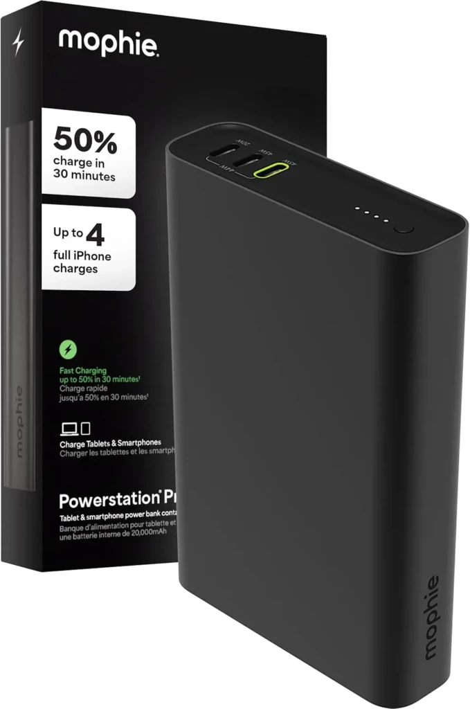 A black Mophie Powerstation Plus power bank next to its retail box, which highlights “50% charge in 30 minutes” and “Up to 4 full iPhone charges,” with visible USB-A and USB-C ports and LED indicator lights on the device, emphasizing fast charging and high capacity for iOS devices.
