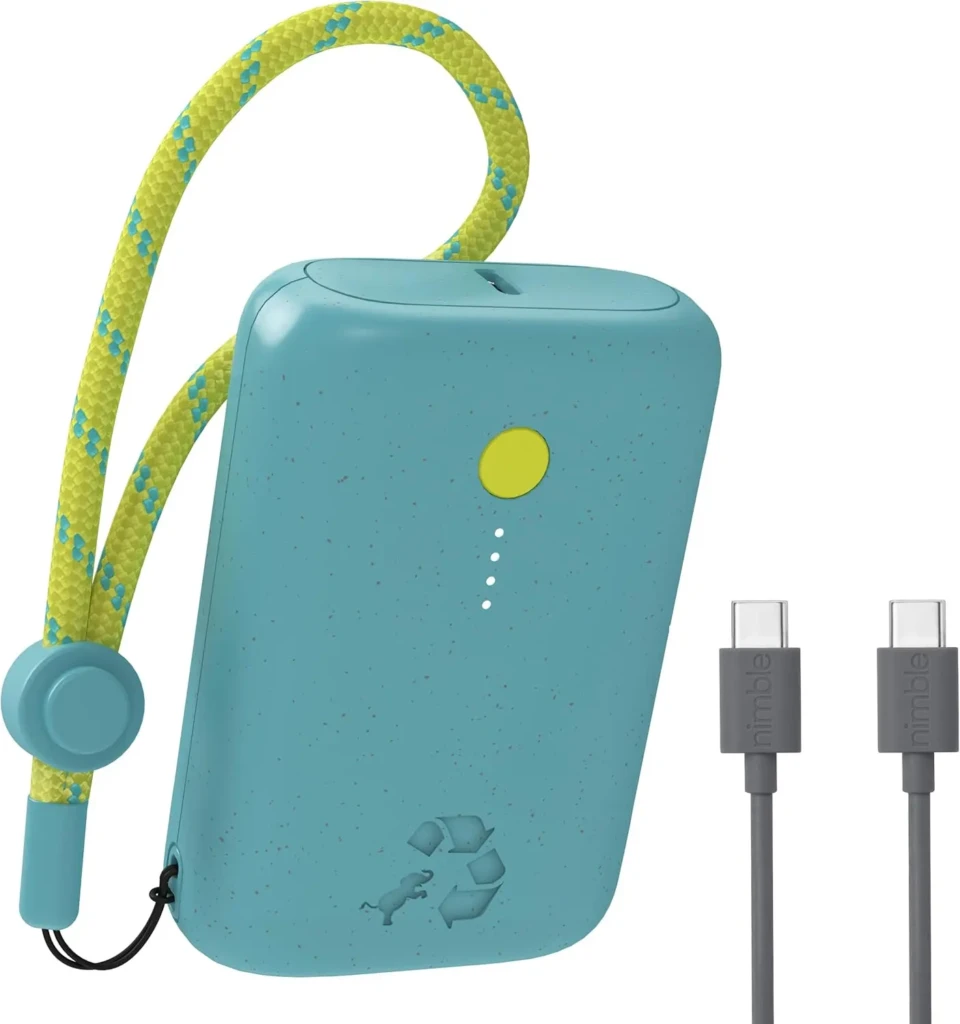 A turquoise eco-friendly power bank by Nimble with speckled texture, a yellow status LED, and a recycled-material recycling symbol; accompanied by a bright yellow-and-teal braided lanyard and two gray USB-C cables labeled “nimble,” emphasizing sustainability and portability.