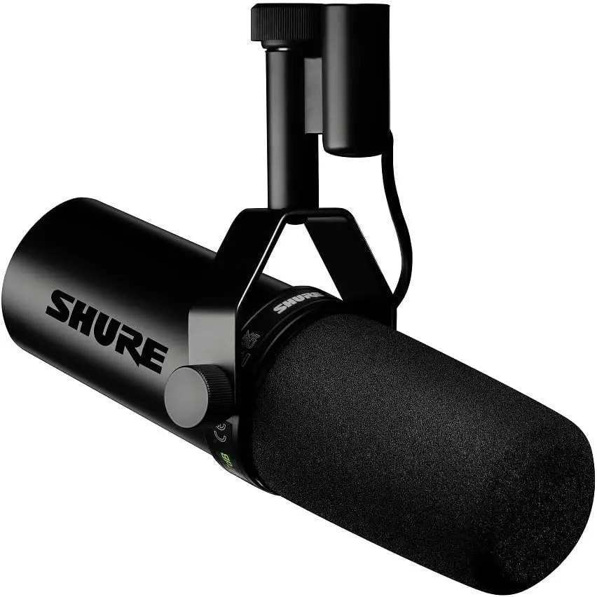 Close-up of a black Shure microphone with a cylindrical body, foam windscreen, and sturdy mount. It conveys a professional audio recording vibe.