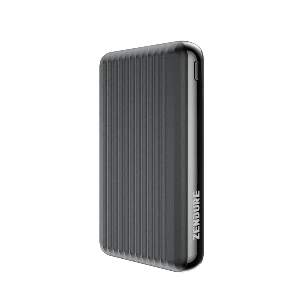 A side view of a dark gray ZENDURE power bank featuring vertical ribbed texture for grip, a sleek metallic edge, and the brand name debossed vertically along the side, showcasing minimalist industrial design and premium build quality.