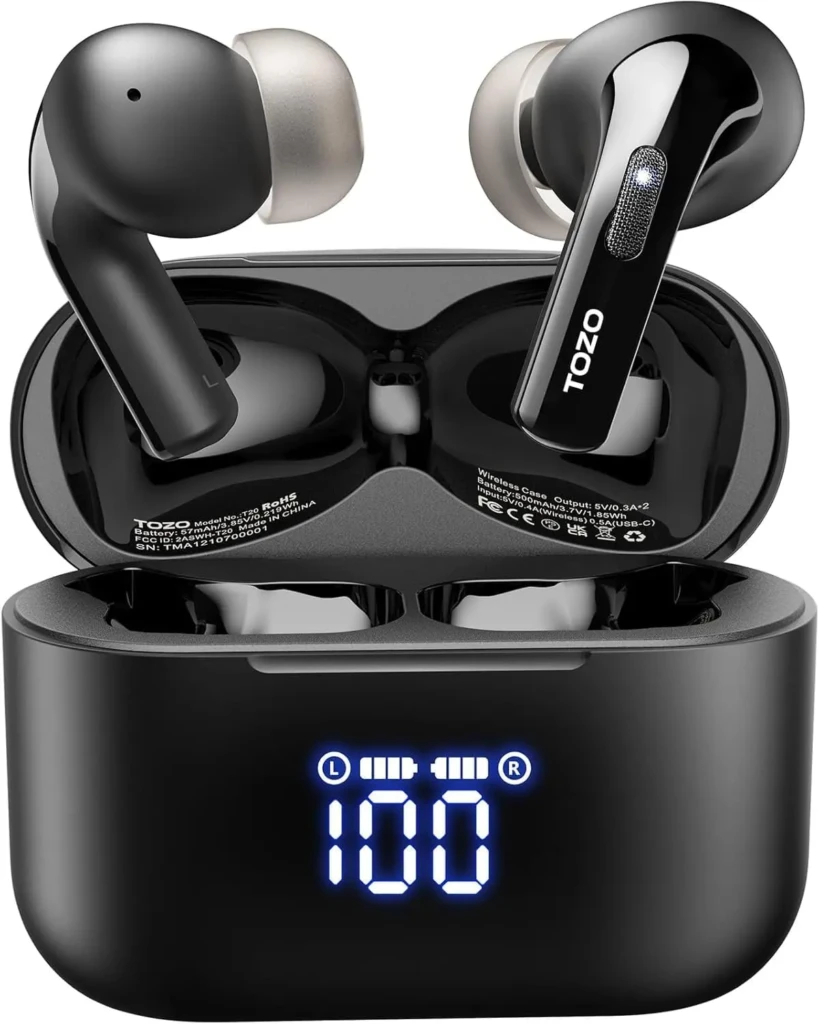 Black TOZO T20 earbuds resting in their open case, which features a bright blue LED display showing “100” (full battery) and L/R indicators; technical specs (model, battery, FCC ID) are visible inside the case lid, demonstrating smart battery monitoring and regulatory transparency.