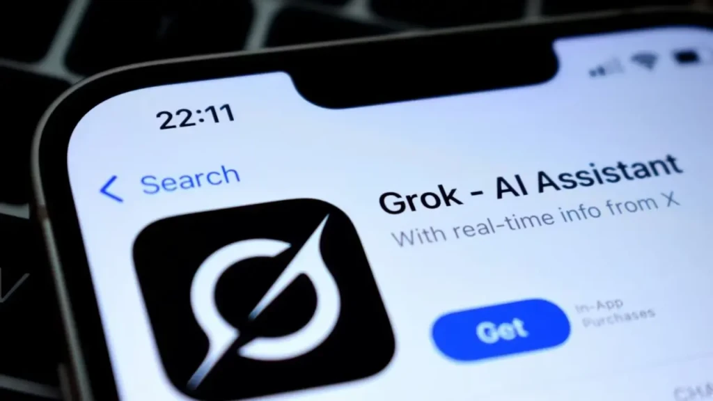 A close-up of an iPhone screen displaying the App Store page for “Grok – AI Assistant,” with the Grok logo, tagline “With real-time info from X,” and a blue “Get” button, highlighting its availability as a mobile application integrated with X (formerly Twitter).