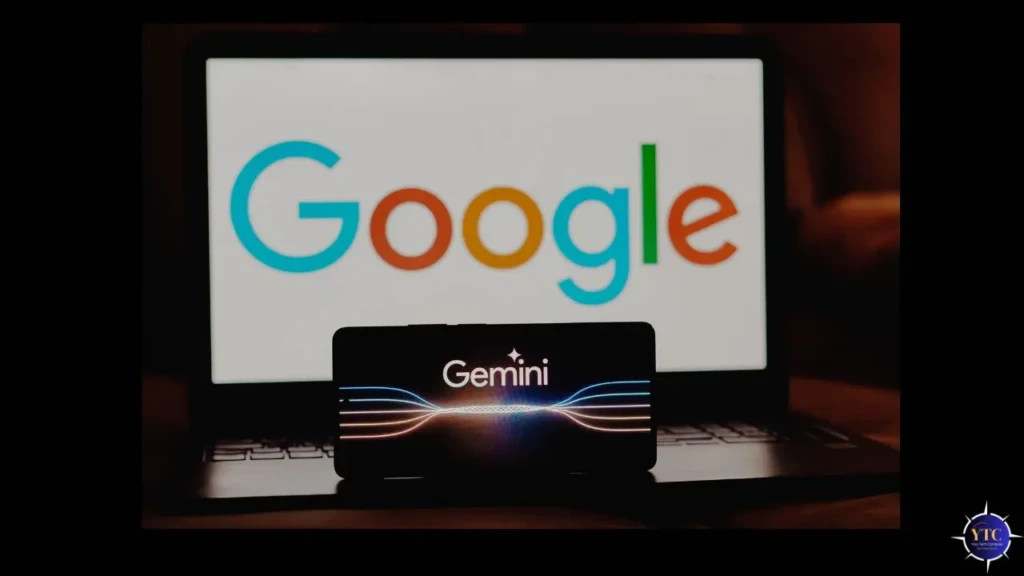 A smartphone displaying the “Gemini” logo with glowing wave-like lines, placed in front of a laptop screen showing the multicolor Google logo, illustrating the integration of Gemini AI across Google’s ecosystem of devices and services.