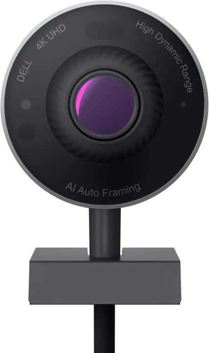 Close-up of a black Dell 4K UHD webcam with AI auto framing and high dynamic range features. The lens is centered and has a purple hue.