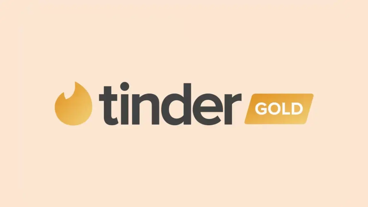 Logo for Tinder Gold featuring a stylized gold flame icon on a light peach background, with "tinder" in black and "GOLD" in white on a gold tag.